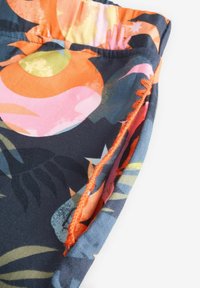 Tume sinine troopilise mustriga kangas, millel on eredate värvidega nagu roosa, oranž ja roheline. Kaitsevdetailid oranži õmblusega.