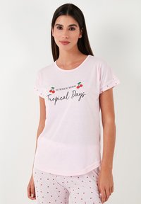 Light pink short-sleeve t-shirt with rounded neckline, featuring "Summer Mood" and "Tropical Days" text, accented by cherry graphics.