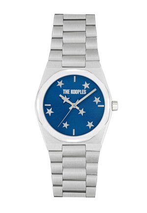 Silver metal watch with a blue dial featuring star markers, marked with "THE KOOPLES." Smooth stainless steel bracelet design.