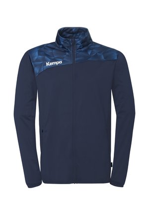Marineblå sportsjakke med lynlås og geometrisk mønster på skuldrene samt "Kempa"-logo på venstre bryst.