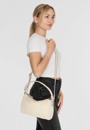 Borsa a tracolla in pelle beige con forma curva, tracolla regolabile e accessori in argento. Texture liscia con design minimalista.