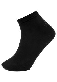 Schwarze Knöchelsocke aus dehnbarem, geripptem Strickmaterial. Verfügt über eine verstärkte Zehenkappe und ein dezentes Markenlogo an der Seite.
