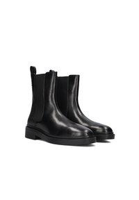 Pair of black leather Chelsea boots with elastic side panels, pull tabs, and low block heels on a white background.