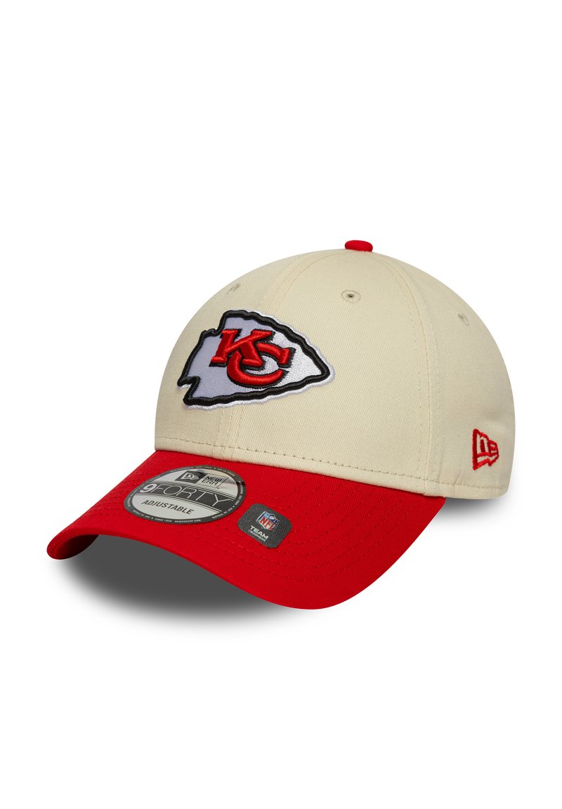 Khaki cap with red brim featuring an embroidered Kansas City Chiefs logo. Fabric is smooth with a structured shape. Adjustable strap at back.