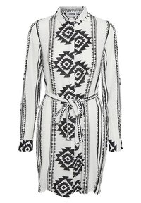 Knappklänning med ett geometriskt svart- och vitt mönster, långa ärmar och ett knytbälte i midjan. Tillverkad av lättviktig tyg.
