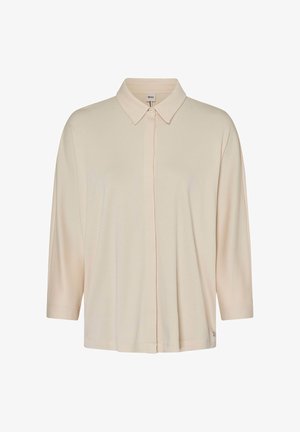 Camicia beige a maniche lunghe con colletto punti e bottoni nascosti, presentata su uno sfondo bianco uniforme.