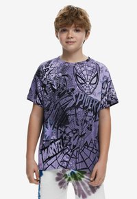 Purple cotton t-shirt featuring Spider-Man graphics, black outlines, and comic-style text, paired with tie-dye pants in green and blue.