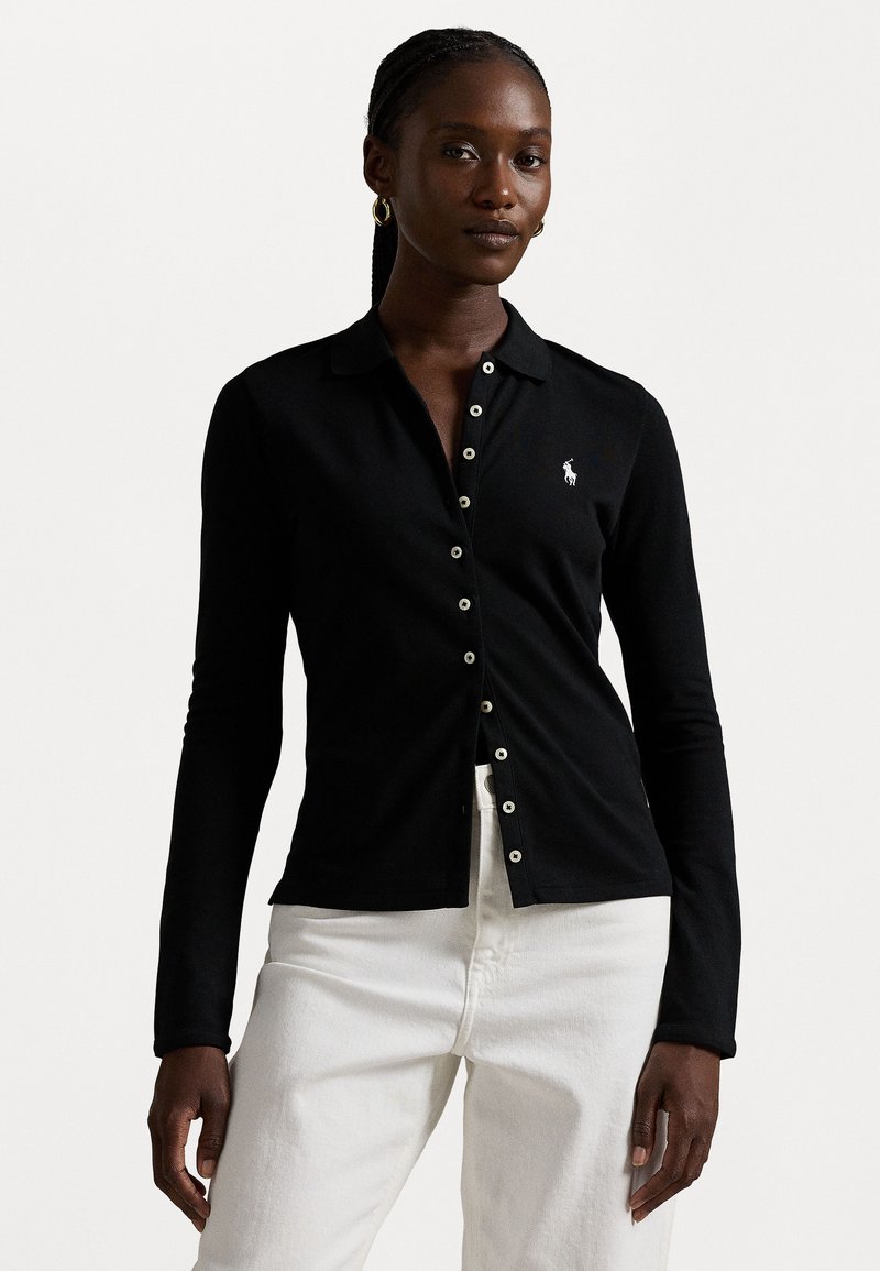 Black long-sleeve polo shirt with a collar, featuring a row of white buttons and a small white logo on the left chest.