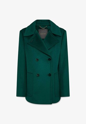 Cappotto di lana verde scuro doppiopetto con ampi risvolti, bottoni neri, due tasche frontali e un'etichetta del marchio all'interno del colletto.