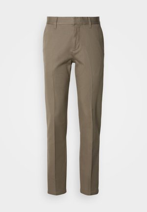 Bēša krāsas bikses no gludas auduma ar taisnu griezumu, priekšpuses rāvējslēdzēju un minimālisma kabatām. Bez redzamiem rakstiem vai akcentiem.