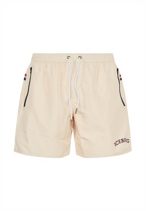 Beige swim shorts with elastic waistband, white drawstrings, black zippered side pockets, small flag detail, and "ICEBERG" logo on left leg.