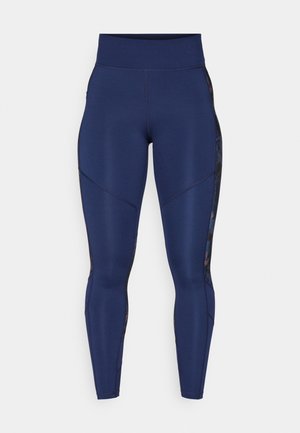 Leggings azul marino con una cintura alta, que presentan paneles texturizados y elegantes a lo largo de los lados y sutilezas en las costuras para un ajuste ceñido.