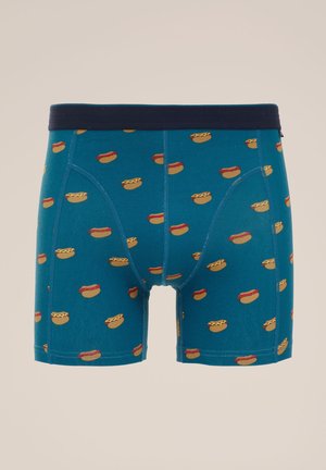 Boxer shorts da uomo in teal, caratterizzati da un motivo a hot dog ripetuto. Vita elastica in navy. Materiale in cotone morbido con una vestibilità comoda.