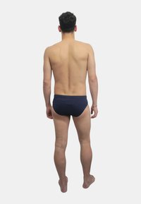 Slip da bagno da uomo in blu navy, design semplice, materiale liscio, vestibilità elasticizzata, con cintura a vita bassa e copertura minima sul retro.