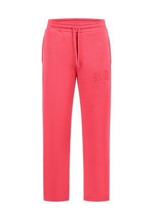 Pantalon de jogging rose corail avec taille élastique, cordon, poches latérales et logo texte discret sur la cuisse gauche.