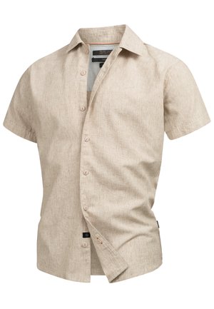 Chemise à manches courtes, col, en beige clair, fabriquée en tissu texturé avec un motif subtil, dotée d'une fermeture à boutons et d'une étiquette de marque au bas.