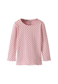 Jasnoróżowa prążkowana bluzka z długim rękawem w czarne groszki. Posiada falbaniasty dół i dekolt. Wykonana z miękkiej bawełny.
