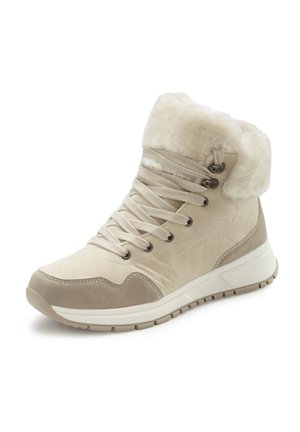 Beige suede ankle boots with a faux fur cuff, featuring beige laces, metal eyelets, and a cushioned white sole. Textured accents on the sides.