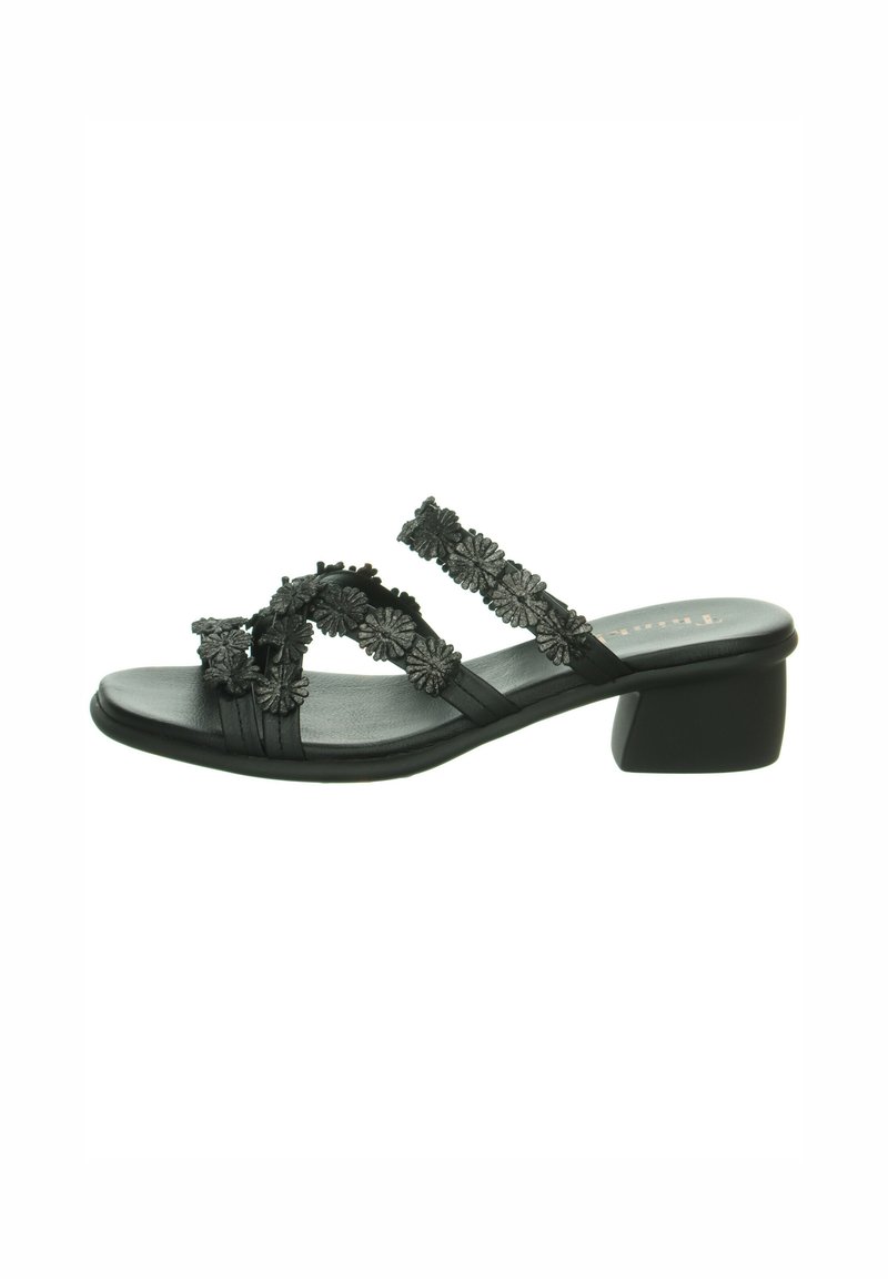 Black block-heeled sandals with floral embellishments, featuring two overlapping straps and a soft, matte finish.