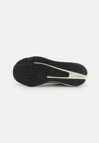 Black rubber shoe sole with textured grip patterns, three circular indentations, and a white accent along the side. Flat design, durable material.