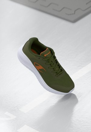 Green athletic shoe with mesh upper, orange accents, cushioned white sole, and textured detailing on the side. Lightweight design.