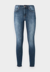 Skinny jeans in dark blue denim. Features a mid-rise waist, five-pocket design, and subtle fading. Hem has a raw edge finish.