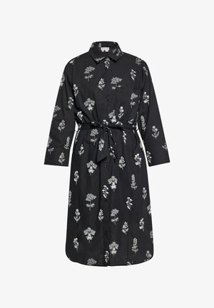 Čierna šaty z látky s golierom, predným zapínaním na gombíky a dlhými rukávmi. Obsahujú biele kvetinové potlače a viazaný pás.