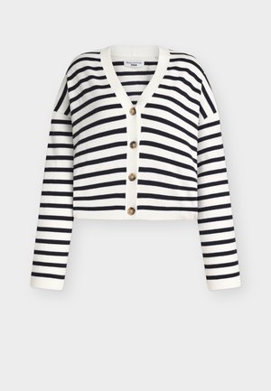 Ριγέ ζακέτα σε λευκό και ναυτικό μπλε, κοντό σχέδιο, V-λαιμόκοψη, μακριά μανίκια, εμπρός κλείσιμο με πέντε στρογγυλά, καφέ κουμπιά. Απαλή υφή.