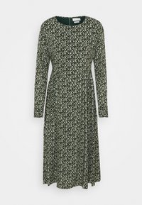 Robe à manches longues en tissu vert foncé avec un motif floral en blanc et jaune pâle. Le design a un col rond et une jupe évasée.
