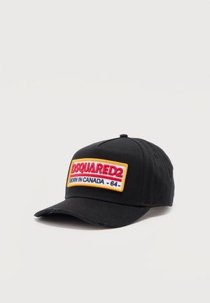Black baseball cap with a patch reading "DSQUARED2 BORN IN CANADA - 64 -" in red, navy, and yellow colors on the front panel.