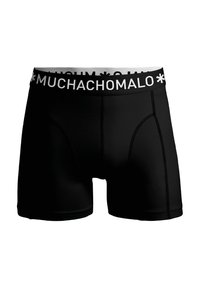 Melni bokseršortai, izgatavoti no elastīgas materiāla, ar piegulošu dizainu. Iezīmēta ar baltu jostu, uz kuras redzams zīmola nosaukums "MUCHACHOMALO".