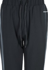 Svarta joggingbyxor i mjukt tyg med elastisk midja och snörning samt sidologotyp. Enkelt mönster och avslappnad passform.