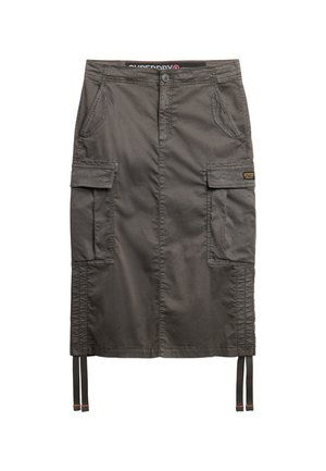 Khaki cargo skirt made of durable fabric, featuring side pockets, stitched detailing, adjustable ties at the hem, and a logo patch.