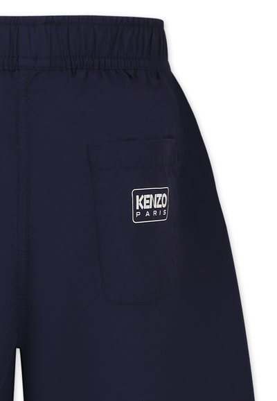 Shorts bleu marine avec taille élastique, présentant une poche patch et une étiquette logo avec "KENZO PARIS" au dos. Texture lisse.