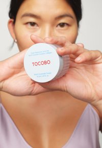 Conteneur circulaire blanc avec une texture rainurée. L'étiquette indique "TOCOBO" en rouge, mettant en avant "Acide Hyaluronique Triple 10%" et "Crème Multi-Céramide".