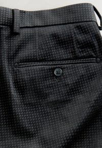 Black patterned trousers featuring a subtle, textured design, buttoned back pocket, and belt loops at the waist.