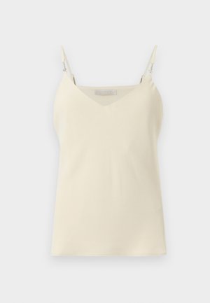 Camisolă de culoare crem, cu bretele subțiri reglabile, decolteu în V și material neted. Are o etichetă subtilă cu brand pe bretea.