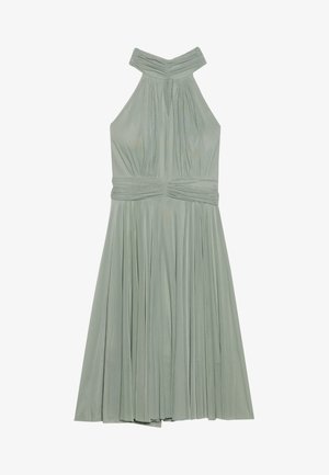 Piparmētru zaļš halter stila kleita ar krokota svārkiem, savāktas kleitas augšdaļas un teksturētu jostasvietu. Izgatavota no viegla auduma.