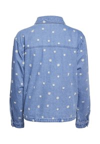 Farkkutakki, vaaleansininen, jossa on valkoista kukkakirjontaa hajautettuna ympäriinsä. Klassinen kaulus, napilliset hihansuut ja takakappaleen muotoilu.