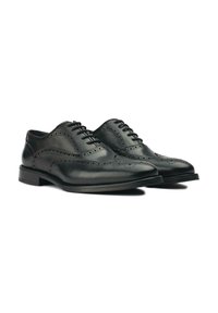 Black leather dress shoes featuring a formal design, wingtip pattern, and a smooth finish. Lace-up closure with a low heel.