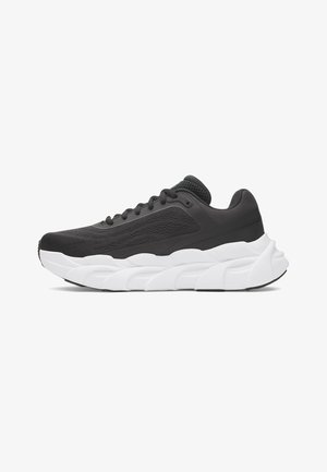 Black athletic shoe with a mesh upper, thick white sole, and textured detailing. Features rounded toe and lace-up closure.