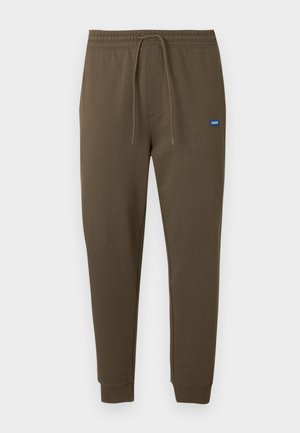 Dark olive green sweatpants with an elastic waistband, drawstring, side pockets, and ribbed cuffs. Small blue logo patch on the left.