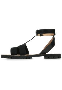 Sandale noire à bout ouvert avec des brides en textile et une semelle en caoutchouc, dotée d'une bride arrière et d'un design plat pour faciliter le port.