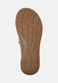 Sole of a shoe featuring a patterned grip, in a brown hue, with brand and size "42" visible on the surface.