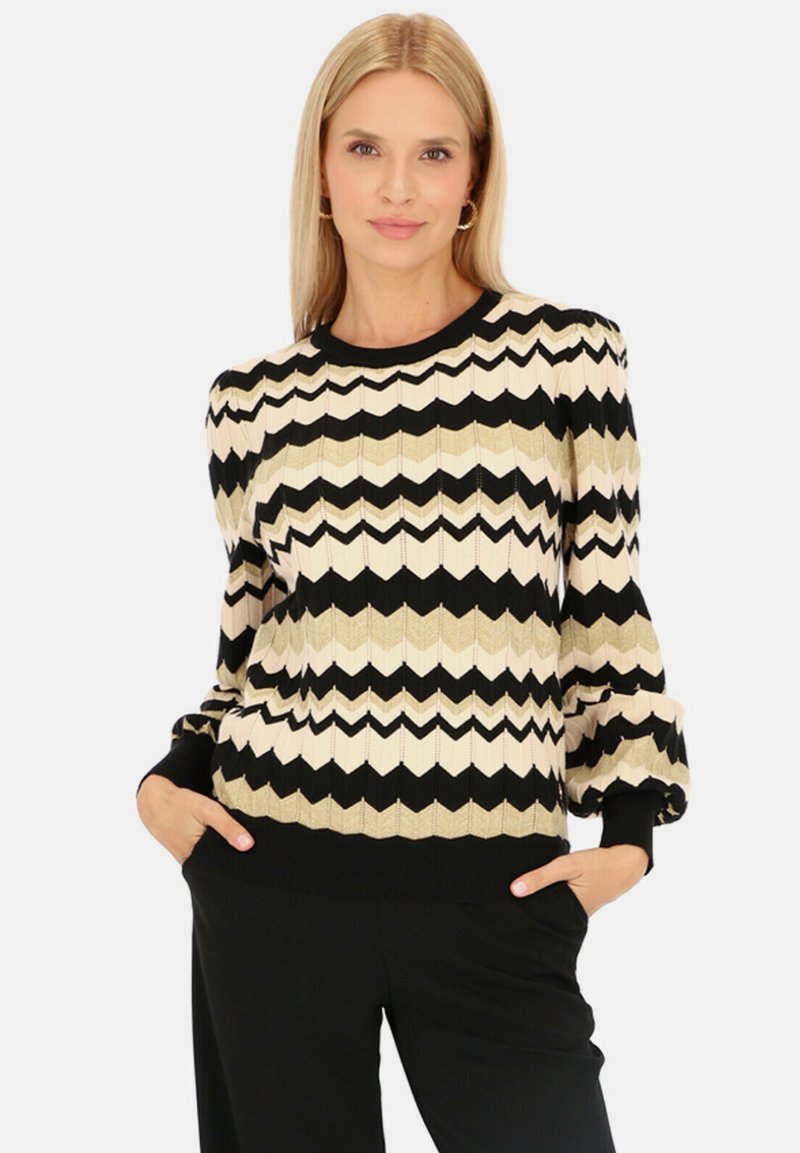 Dzianinowy sweter w zygzakowy wzór w kolorach czarnym, kremowym i złotym. Struktura prążkowana, okrągły dekolt, długie rękawy i dopasowane mankiety.