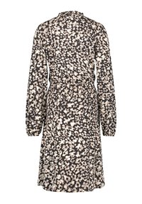 Robe noire à motifs avec manches longues, taille élastique, encolure à volants et un motif floral dans des tons beige et crème.