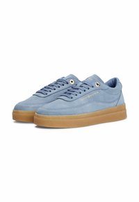 Blaue Wildledersneaker mit Gummisohle, ausgestattet mit flachen Schnürsenkeln, goldenen Ösen und geprägtem Branding an der Seite. Runde Zehenpartie und flaches Design.