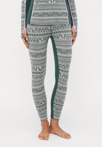 Leggings with a geometric pattern in green and gray, featuring a smooth texture, contrasting side panels, and subtle pink accents.