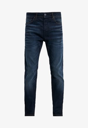 Sötétkék, slim-fit farmernadrág elülső zsebekkel, gombos záródással és diszkrét kopási részletekkel a combokon és a térdeken.