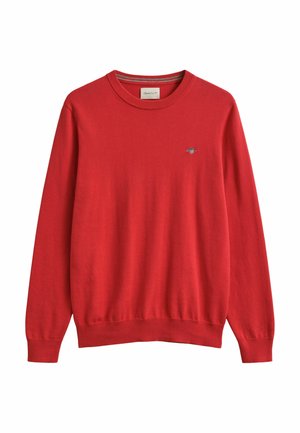 Pull rouge à manches longues avec col rond, poignets et ourlet côtelés, petit logo brodé sur la poitrine gauche, présenté sur fond blanc.